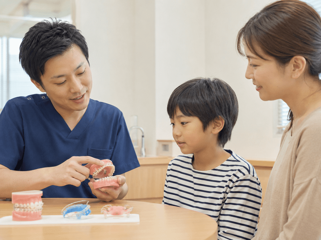 矯正装置の説明を聞く親子